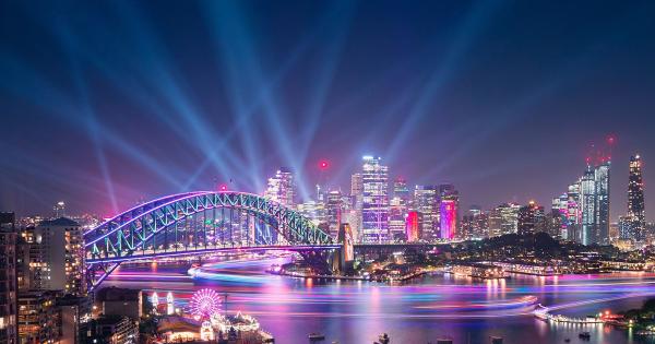 Sydney Harbour with Harbour Bridge illuminated in lights at night