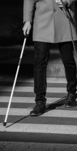Person walking with a white cane