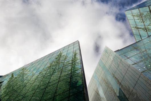 glass buildings with trees reflected. Adobe Stock