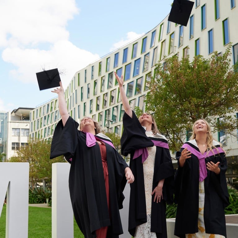 Graduates throwing trenchers