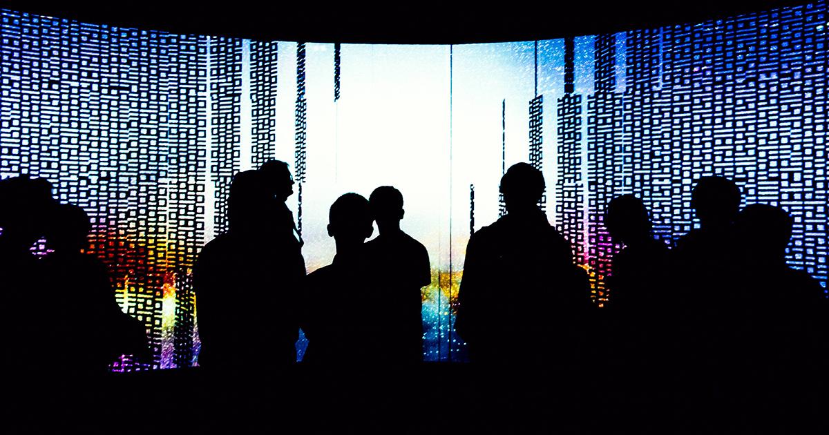 Silhouetted people inside the UTS Data Arena