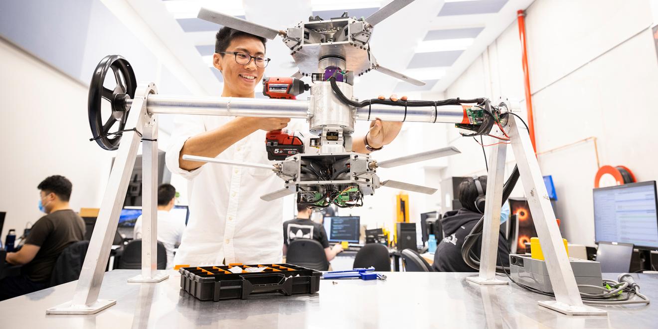 Researchers and students developing robots in the lab