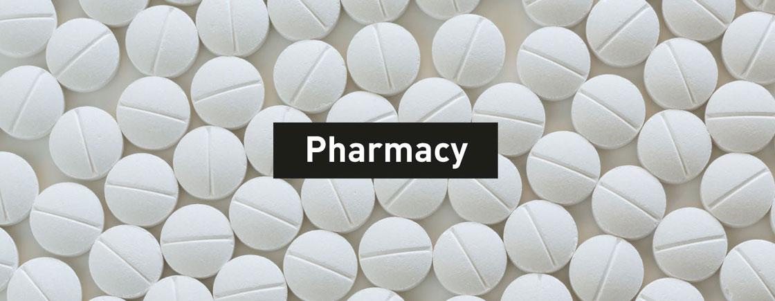 Banner image.  White pharmaceutical tablets with text Pharmacy overlay.
