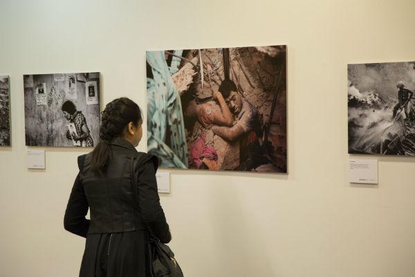 Woman viewing photo at Rana Plaza exhibition