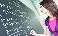 A student doing mathematics on a blackboard