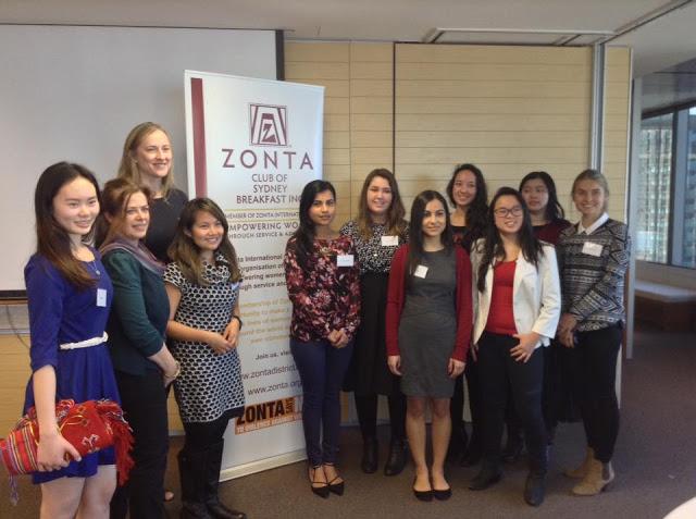 A crowd of women, primarily UTS students, posing for a photo with the Zonta banner