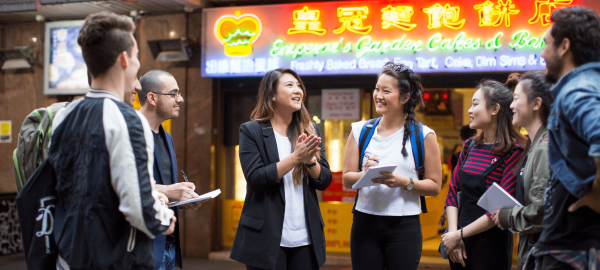 A group of students in Chinatown taking notes