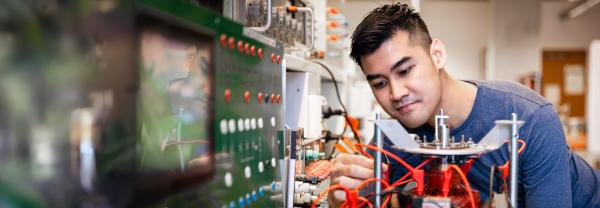 Male student studying electrical engineering