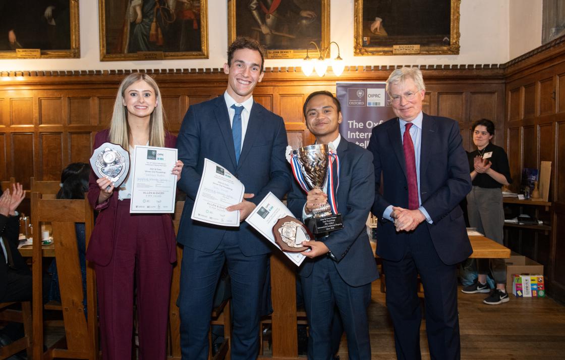 Prize winners holding mooting cup and certificates