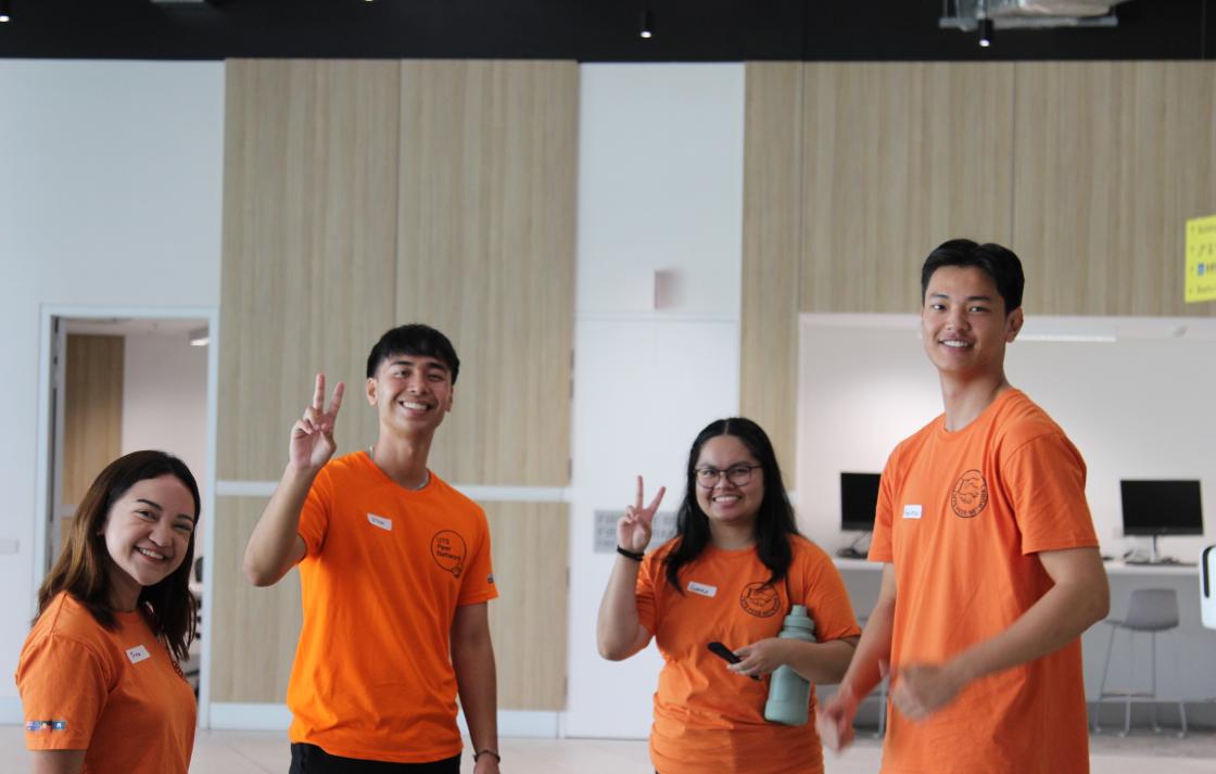 Four Peer Networkers smiling, standing in Building 2 at UTS. 