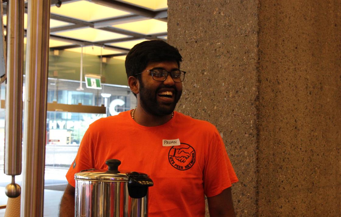 A Peer Networker laughing at the Orientation coffee cart