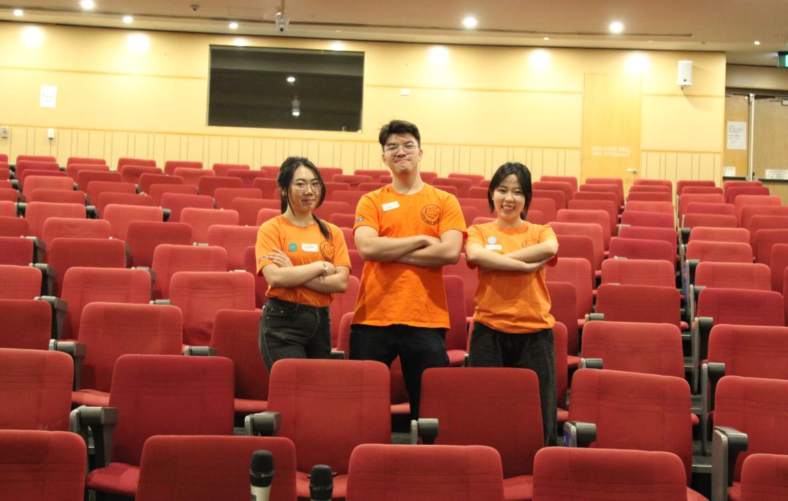 Peer Networkers with their arms crossed in an auditorium