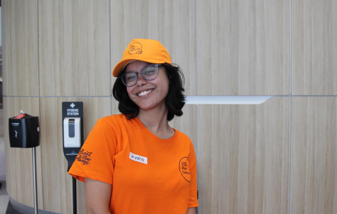 A Peer Networker smiling with merchandise