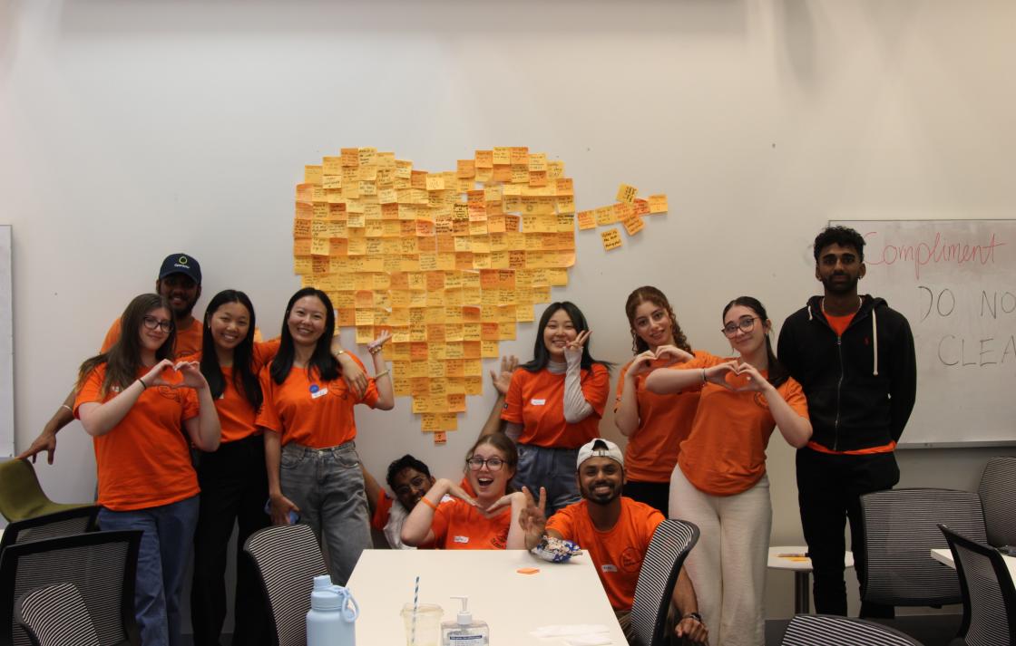 Peer Networkers posing with a heart made of sticky notes