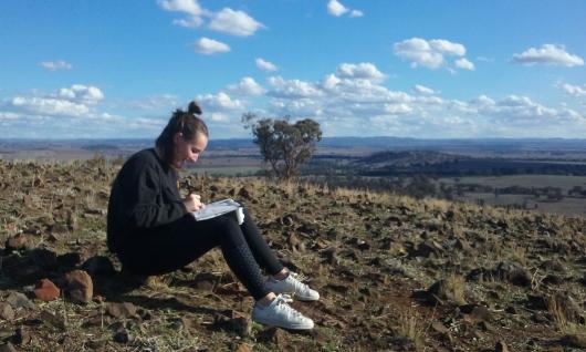UTS Interior Architecture student sitting and drawing in Dubbo landscape