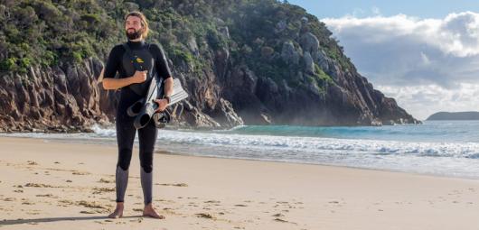 man in wetsuit on the beach