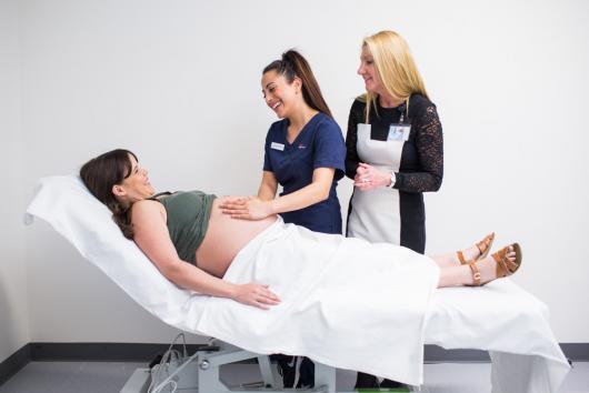 UTS midwifery student examines a pregnant woman