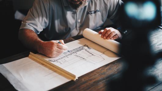 Construction design being drawn by architect 