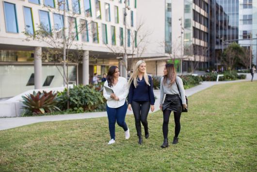 UTS students walking on the grass in front of Graduate School of Health