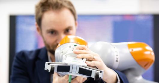 Close up of man adjusting robotic equipment