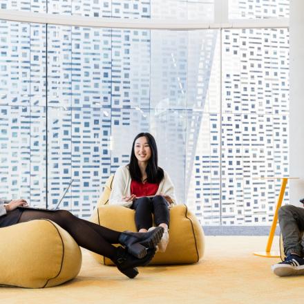 Three students sit on bean bag chairs in UTS Central.