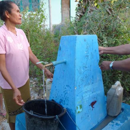 Indonesia outside Kupang - people using a third world water tap