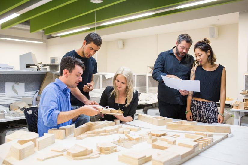 5 people working together on a architecture model