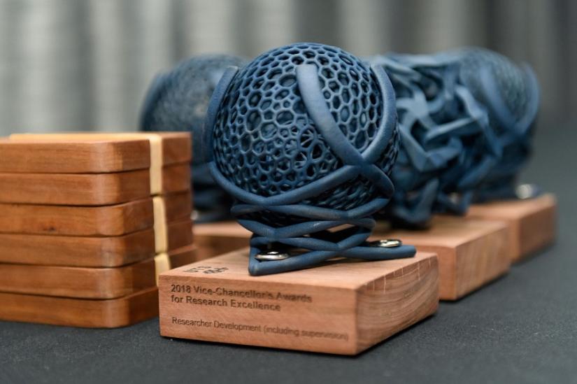 Photo of 3D-printed globe-shaped research award statuettes, , designed by Professor Jennifer Loy, School of Design. Photo: Encapture Photography.