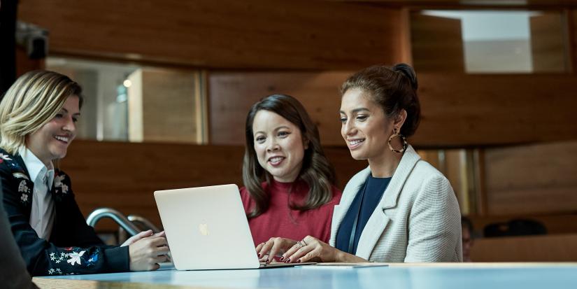 Three women on a laptop studying