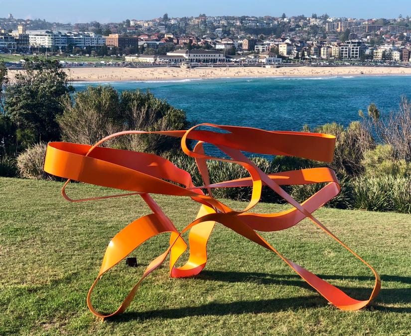 Jim Flook's sculpture Swerve One in front of a coastal backdrop