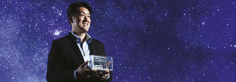Joshua Chou holding the prototype microgravity device 