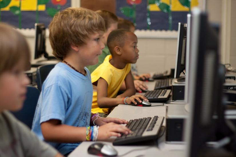 young students learning at desktop computers