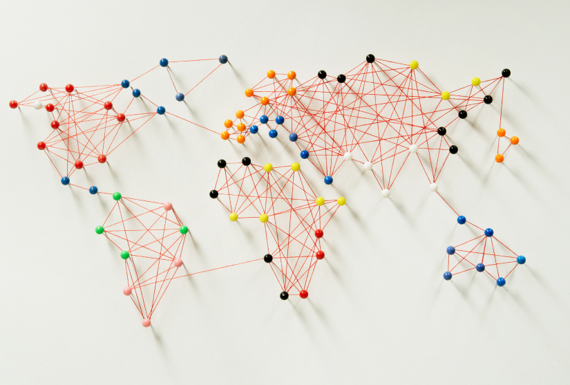 Coloured pins arranged to imply a world map
