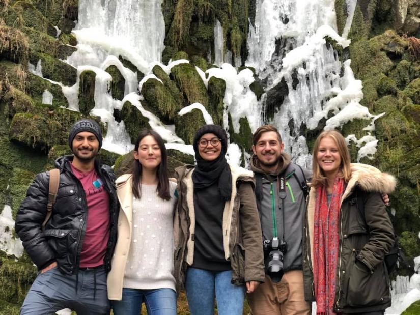 International Studies students stand in front of a waterfall in Germany