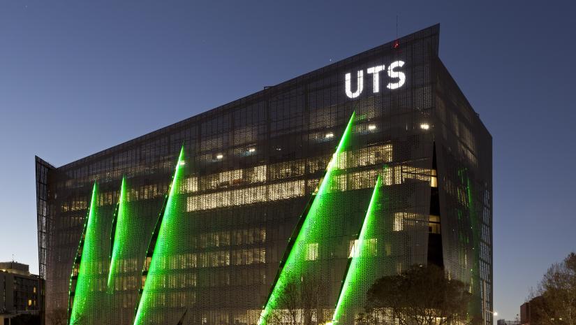 Twilight view of exterior of UTS engineering building, showing twinkling lights within the building.