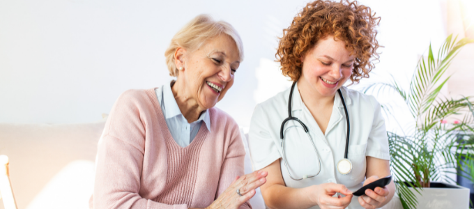 Nurse laughing with and supporting diabetes patient