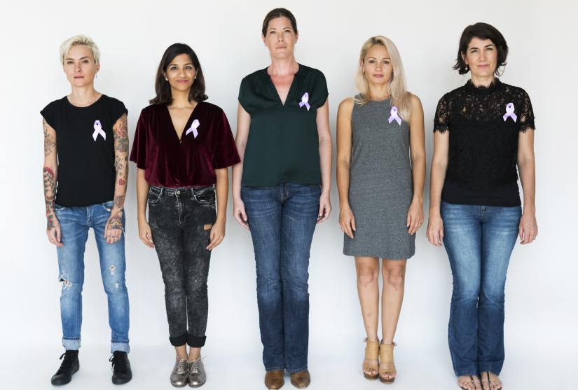 Group of diverse people wearing purple cancer ribbon