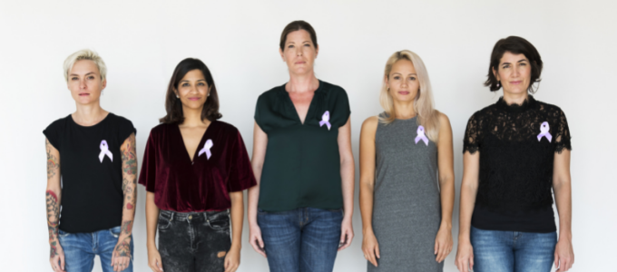 Group of diverse people wearing purple cancer ribbon