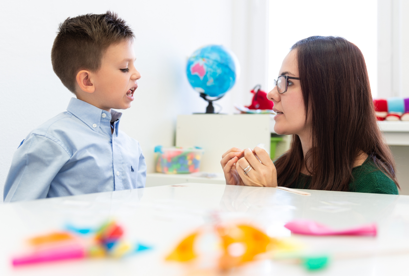 Speech Pathologist assisting young boy