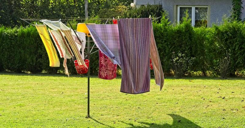 Towels drying on a Hills Hoist in a backyard