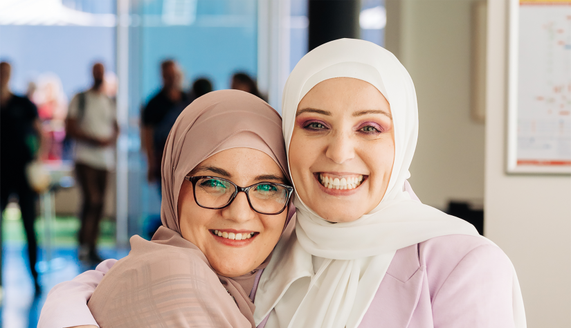 Dr Rayan Saleh Moussa and Nadine El-Kabbout hugging and smiling at camera