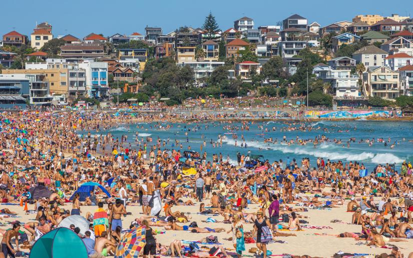 Very crowded but immensely popular Bondi Beach in Sydney. Thousands of sun lovers will gather here to swim and surf on any sunny day, tourists and locals alike.