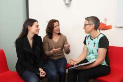 Two female clients sitting and talking with genetic counsellor