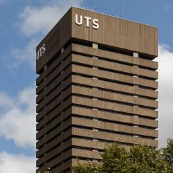 The square concrete form of the brutalist UTS Tower rises into the blue skies