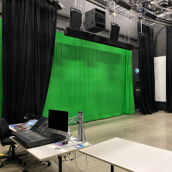Media lab facilities including mixing desk, monitor and the green screen in the background