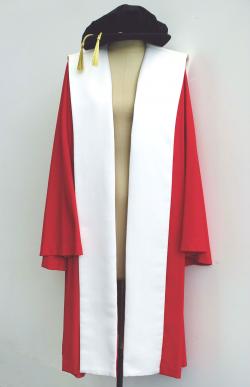 PhD gown - red with white satin trim and a black bonnet with gold tassel