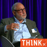 Joseph Stiglitz sitting on a chair