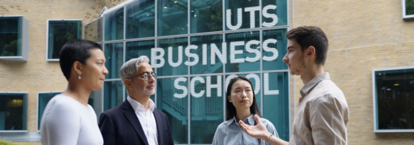 Three students and an academic standing in front of the UTS Business School 
