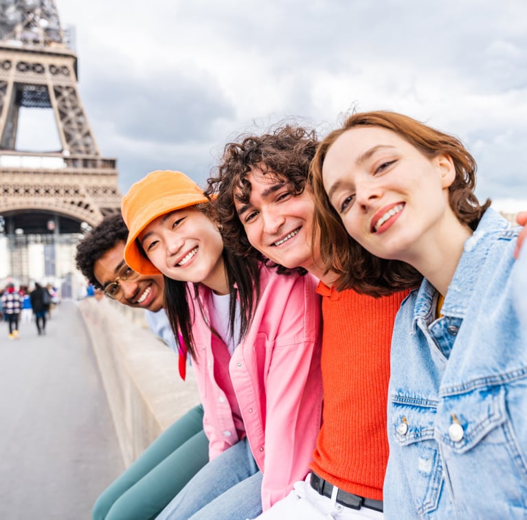 Group of young happy friends visiting Paris and Eiffel Tower, Trocadero area and Seine river
