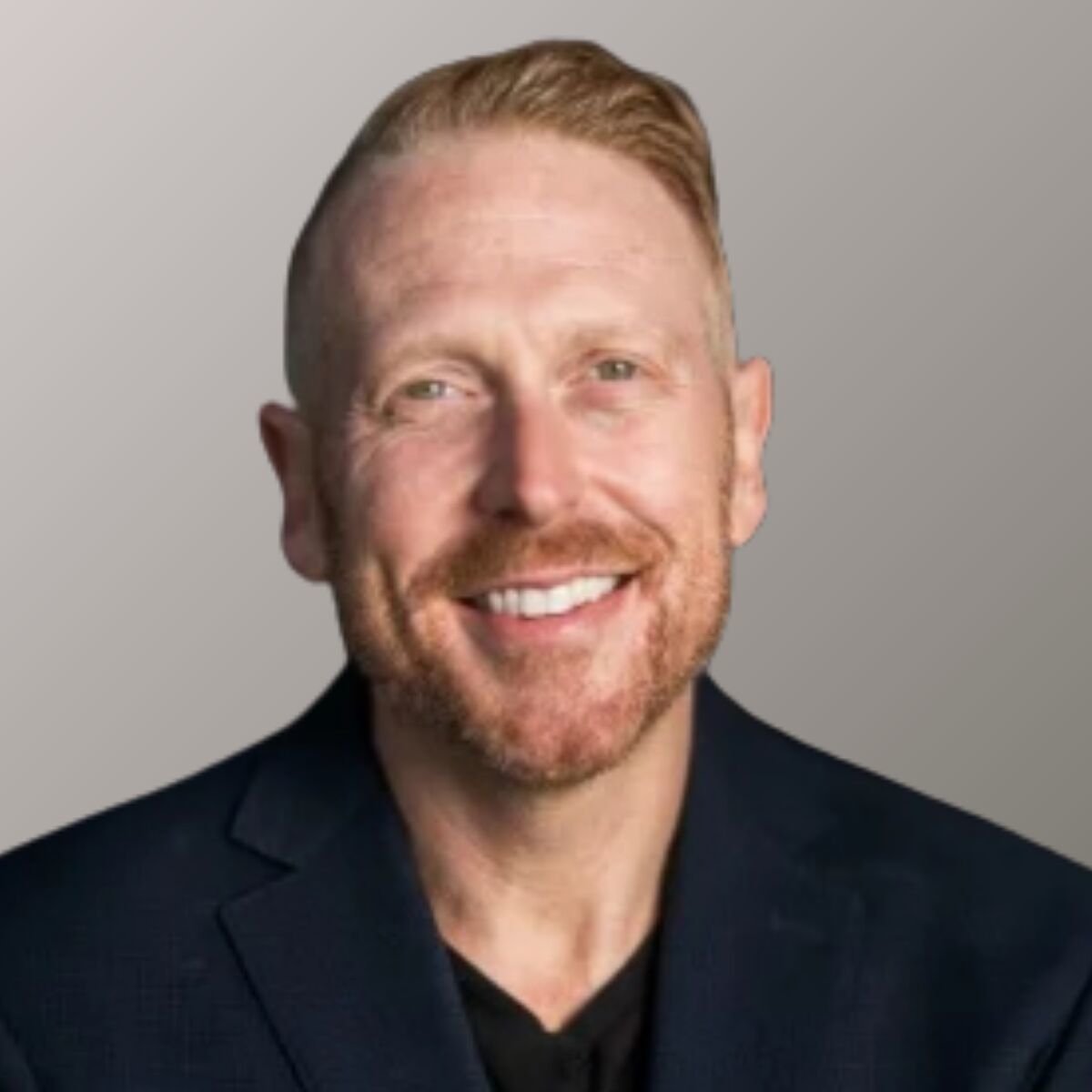 Portrait of Craig Scroggie. He's wearing a black dress shirt.